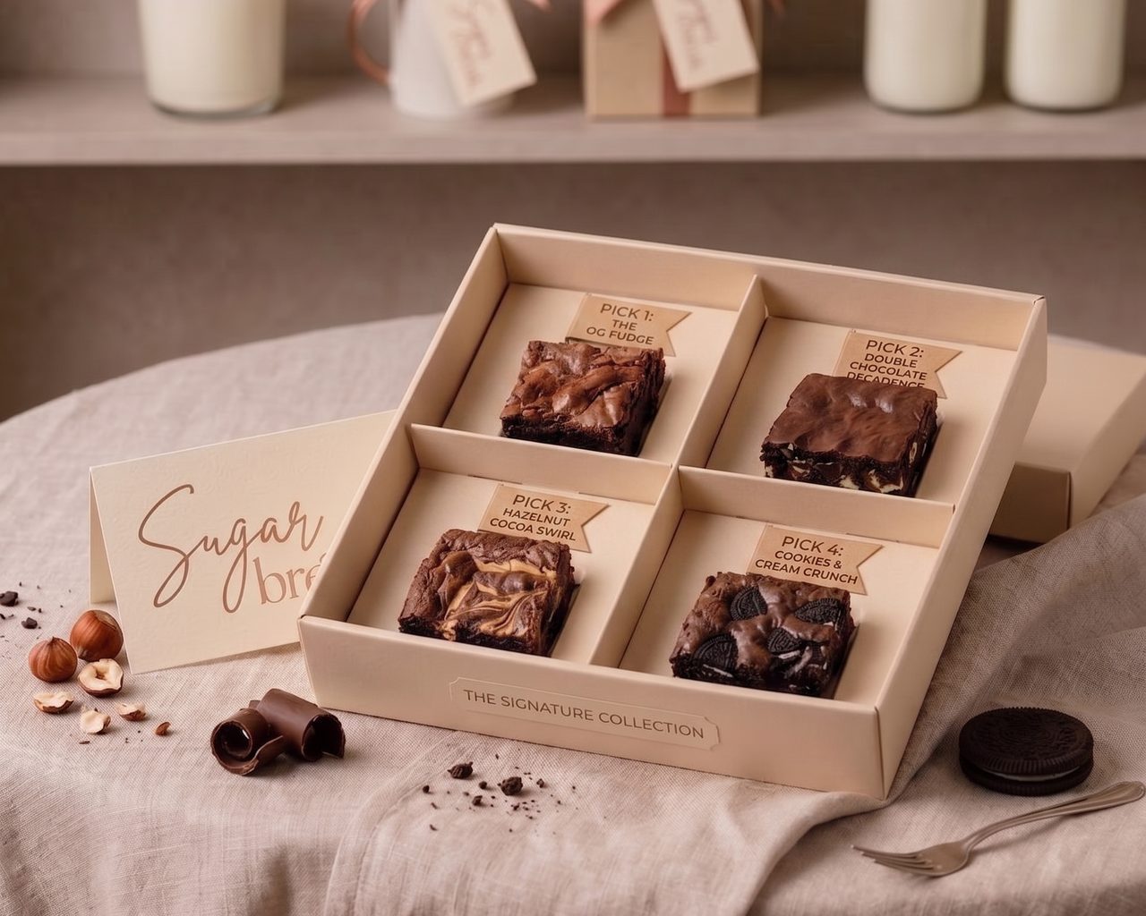 One Four All, a kraft box with one labelled piece of each Sugar bréak flavour: OG fudge, cookies & cream, hazelnut cocoa swirl, and double chocolate